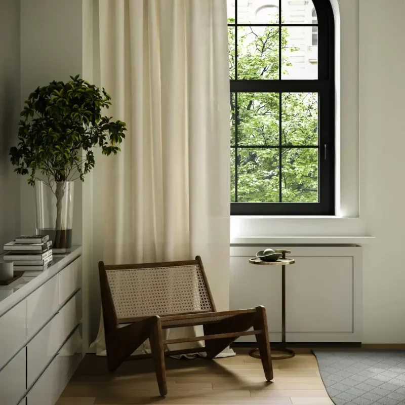 Luxurious silk drapes in a pale gold color, gently gathered into formal pinch pleats, creating a refined look.